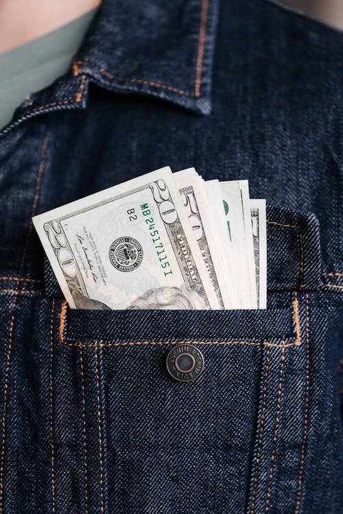 Crop man with various banknotes in pocket